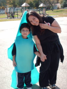 Rosario (age 5) on the playground at school in a Dolphin costume for Halloween with his mother DeeDee.