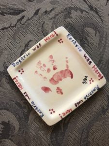 A ceramic yellow plate with Rosario's handprint (age2).