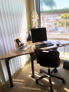 Corner desk with chair by window 